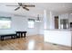 Open living area with light wood floors and a breakfast bar at 808 S Green Cir, Venice, FL 34285
