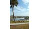 Scenic waterfront view with palm trees, benches, and boats at 808 S Green Cir, Venice, FL 34285