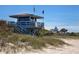 Beachfront view with lifeguard stand and ocean at 809 Garland Ave, Nokomis, FL 34275