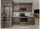 Modern kitchen with stainless steel appliances and dark wood cabinets at 809 Garland Ave, Nokomis, FL 34275