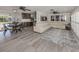 Open living space with a sectional sofa, large TV, and dining area at 809 Garland Ave, Nokomis, FL 34275