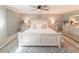 Main bedroom with a white bed frame and nightstands at 828 The Rialto, Venice, FL 34285