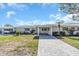 Single story home with paved driveway and mature trees at 833 White Cap Cir # 8, Venice, FL 34285