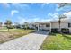 Landscaped front yard with brick pavers driveway at 833 White Cap Cir # 8, Venice, FL 34285