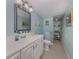Bathroom with light blue walls, white vanity and large mirror at 842 Linden Rd, Venice, FL 34293