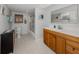 Clean bathroom with wood vanity, shower/tub combo and toilet at 842 Linden Rd, Venice, FL 34293