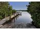 Wooden boat dock extending over calm water, with a boat moored nearby at 842 Linden Rd, Venice, FL 34293