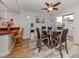 Bright dining room with glass table and four chairs, adjacent to kitchen at 842 Linden Rd, Venice, FL 34293