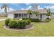Gray house with white garage door, landscaped lawn, and screened porch at 842 Linden Rd, Venice, FL 34293