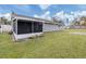 Gray house exterior with screened porch, grassy yard, and RV parking at 842 Linden Rd, Venice, FL 34293