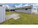 House exterior showcasing gray siding, a spacious backyard, and a concrete pad at 842 Linden Rd, Venice, FL 34293