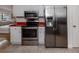 Kitchen with red countertops, stainless steel appliances, and white cabinets at 842 Linden Rd, Venice, FL 34293