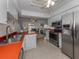 Kitchen with red countertops, white cabinets, and stainless steel appliances at 842 Linden Rd, Venice, FL 34293