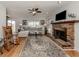 Living room with brick fireplace, hardwood floors, and comfy seating at 842 Linden Rd, Venice, FL 34293