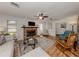Living room with brick fireplace, hardwood floors, and comfy seating at 842 Linden Rd, Venice, FL 34293
