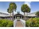 Park building with a walkway, palm trees, and lush landscaping at 842 Linden Rd, Venice, FL 34293