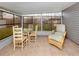 Screened porch with wicker furniture and glass-top table at 842 Linden Rd, Venice, FL 34293