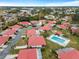 Wide aerial view of community with homes, landscaping, and a pool at 854 Senda Plata # 22, Venice, FL 34293