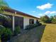Back of house showing sliding glass doors leading to a grassy backyard at 854 Senda Plata # 22, Venice, FL 34293
