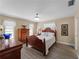 Bedroom with wooden furniture and white bedding at 854 Senda Plata # 22, Venice, FL 34293
