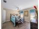 Bedroom with teal bedding, wood flooring and ceiling fan at 854 Senda Plata # 22, Venice, FL 34293