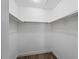 Empty walk-in closet with white walls and wooden shelves at 854 Senda Plata # 22, Venice, FL 34293