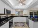 Updated kitchen with white cabinets, granite countertops, and stainless steel appliances at 854 Senda Plata # 22, Venice, FL 34293