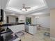 Modern kitchen with white cabinets, granite countertops, and stainless steel appliances at 854 Senda Plata # 22, Venice, FL 34293