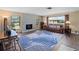 Spacious living room with a stone fireplace, leather sofa, and large windows at 854 Senda Plata # 22, Venice, FL 34293