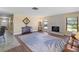 Bright living room with hardwood floors, stone fireplace, and ample natural light at 854 Senda Plata # 22, Venice, FL 34293