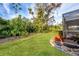 Landscaped backyard with grassy area and screened enclosure at 858 Senda Plata # 20, Venice, FL 34293