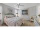Comfortable bedroom with flamingo bedding and ceiling fan at 858 Senda Plata # 20, Venice, FL 34293