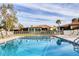 Inviting community pool with lounge chairs and lush landscaping at 858 Senda Plata # 20, Venice, FL 34293