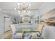 Bright dining area featuring a glass-top table and stylish chandelier at 858 Senda Plata # 20, Venice, FL 34293