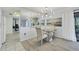 Charming dining area with glass table and modern chandelier at 858 Senda Plata # 20, Venice, FL 34293