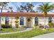 Single story home with a tile roof and a walkway to the entrance at 858 Senda Plata # 20, Venice, FL 34293