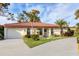 Single-story home with tile roof, attached garage, and a landscaped yard at 858 Senda Plata # 20, Venice, FL 34293