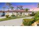 Single-story home with a tile roof, landscaped yard, and a paved driveway at 858 Senda Plata # 20, Venice, FL 34293