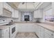 Modern kitchen featuring white cabinets and updated appliances at 858 Senda Plata # 20, Venice, FL 34293