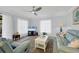 Living room featuring light walls, comfortable seating, and a large TV at 858 Senda Plata # 20, Venice, FL 34293
