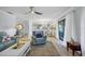 Open concept living room with comfortable seating and access to patio at 858 Senda Plata # 20, Venice, FL 34293