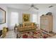 Relaxing sitting area featuring a floral sofa and ceiling fan at 858 Senda Plata # 20, Venice, FL 34293