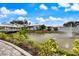 Peaceful lake with a fountain and clubhouse in the background at 900 Paisley Ct # 1, Venice, FL 34293