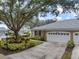 Exterior view of home with attached garage and landscaping at 900 Paisley Ct # 1, Venice, FL 34293