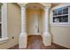 White front door entrance with decorative columns at 901 Triano Cir # 901, Venice, FL 34292