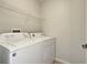Laundry room with washer, dryer and overhead shelving at 901 Triano Cir # 901, Venice, FL 34292