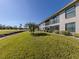 Exterior view showing building and landscaping at 936 Capri Isles Blvd # 102, Venice, FL 34292