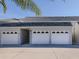 Three-car garage with attached entryway to condo building at 936 Capri Isles Blvd # 102, Venice, FL 34292