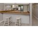 Bright kitchen features white cabinets, wood countertops, and modern appliances at 936 Capri Isles Blvd # 102, Venice, FL 34292