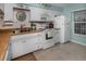 White kitchen with wood countertops, stainless steel appliances and teal walls at 936 Capri Isles Blvd # 102, Venice, FL 34292